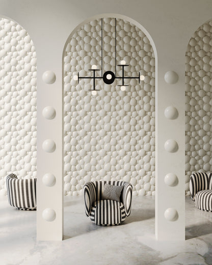 Image features an interior design of a residential or commercial space with backdrop wall and arches made of 3d wall panels from plaster. The interior is modern and luxurious, featuring whimsical modern furniture. 3D wall panels have a high-end porcelain plaster finish effect and bubble or foam-like organic pattern. Interior is in subtle white grey and beige colors. 
