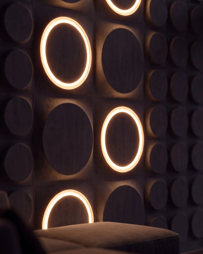 Close up of COSMIC 0012 LED gypsum 3D wall panels with illuminated rings at night