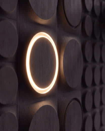 Single COSMIC 0012 LED gypsum 3D wall panel with warm halo ring, side view