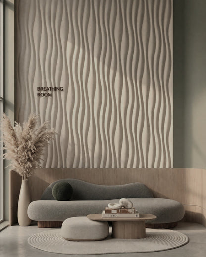 Kandes RIPPLE 0076 gypsum 3D wall panels on a lounge feature wall above a curved sofa