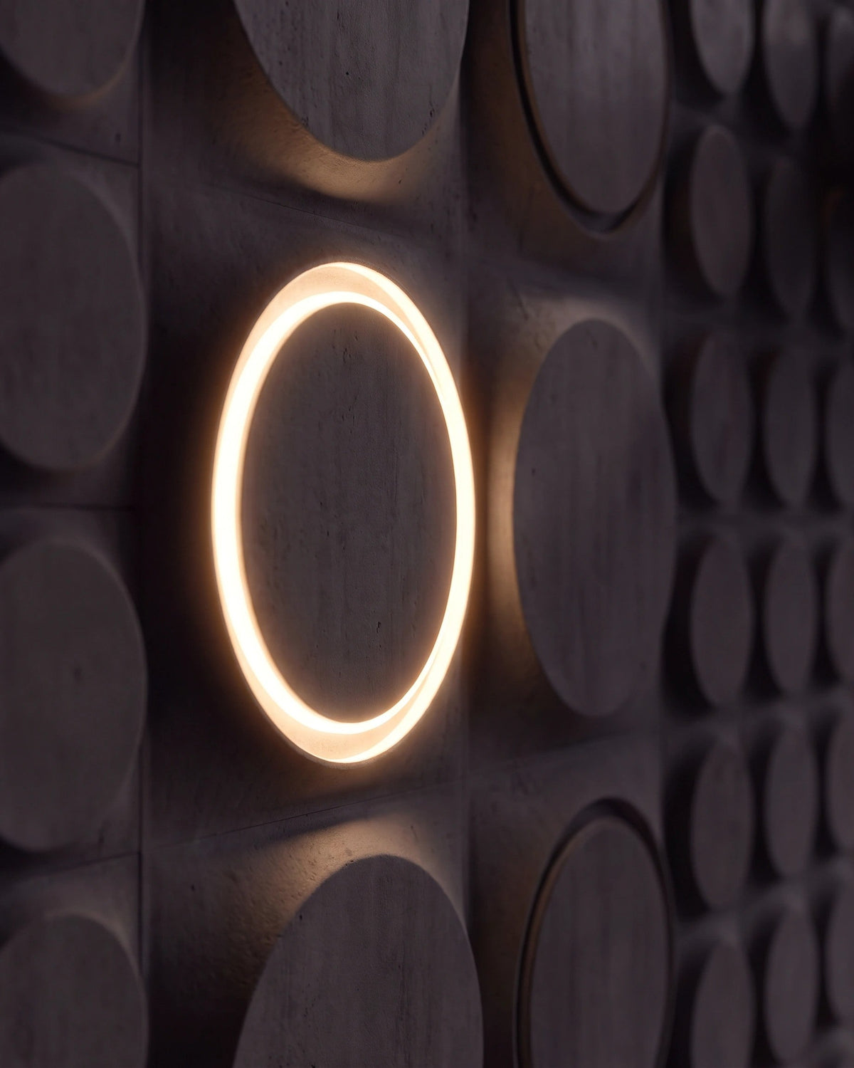 Single COSMIC 0212 LED gypsum 3D wall panel with warm halo ring in side view